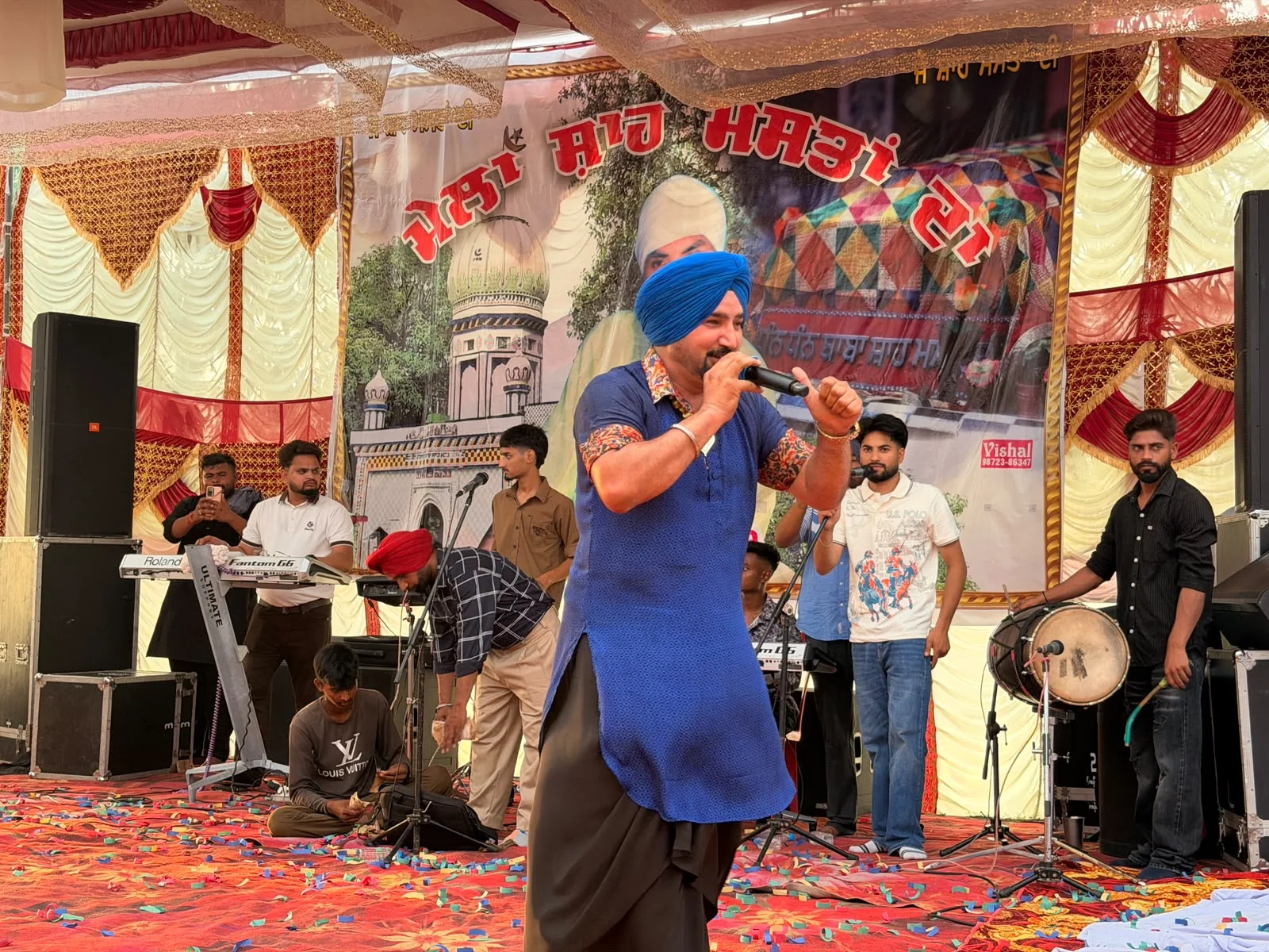 Prabh Sheron performing during a Punjabi live music show